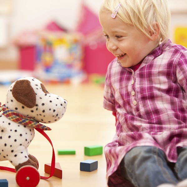 Girl Playing with Toy Dog