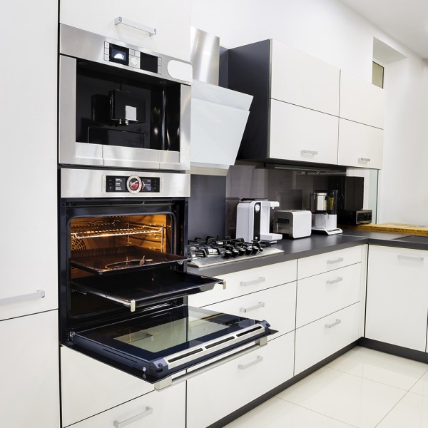 Modern luxury hi-tek black and white kitchen, clean interior design, focu at oven with door open