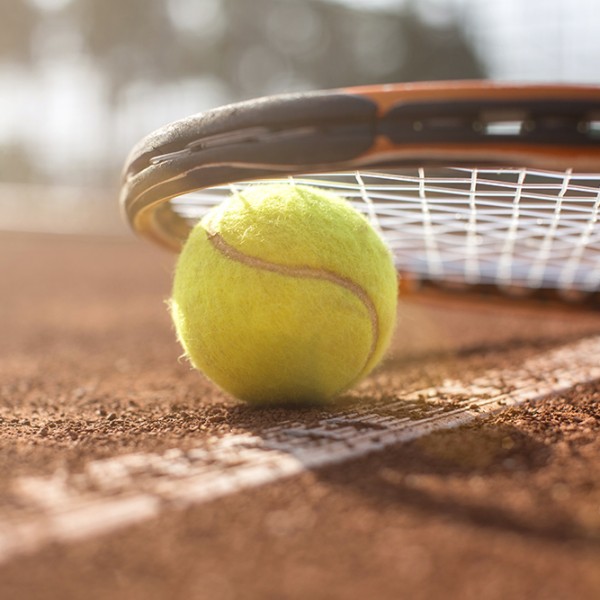 tennis court with tennis ball and racket